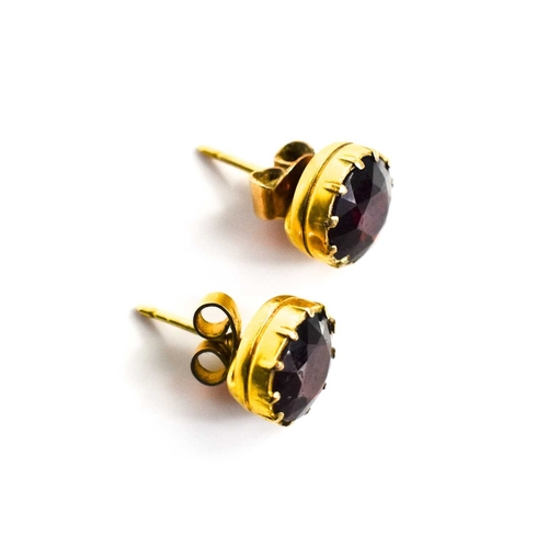 12 - A pair of 9ct gold and garnet stud earrings, old European cut in enclosed setting, with butterfly ba... 