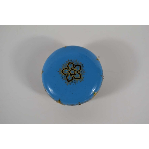261 - A 19th century, likely French blue enamel pill box, handpainted with floral motifs in white blue and... 