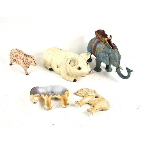 311 - A group of four vintage cast iron money banks, in the form of an elephant, sheep and a pig.