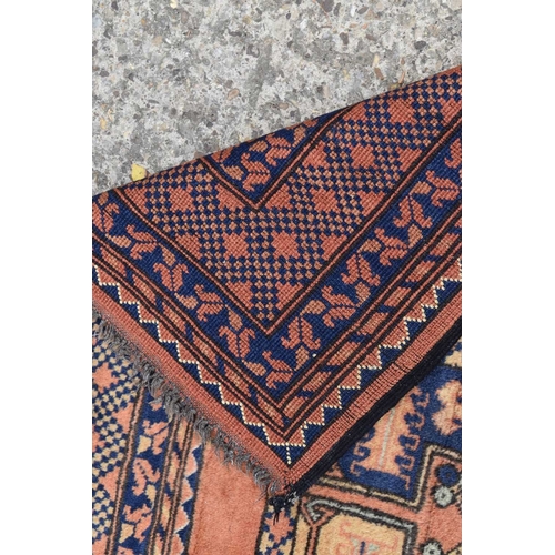 316 - An antique Middle Eastern wool rug, with orange ground and repeating foliate and geometric border wi... 