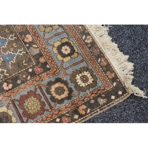 318 - A Turkish wool rug, red ground with traditional geometric motifs and a central medallion design, 240... 