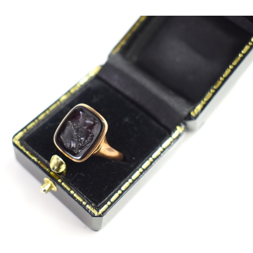 A 9ct gold and black-stone intaglio ring, the rectangular stone carved ...