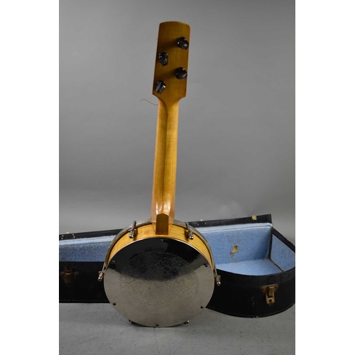 A vintage banjo with engraved backplate and the original hard case.