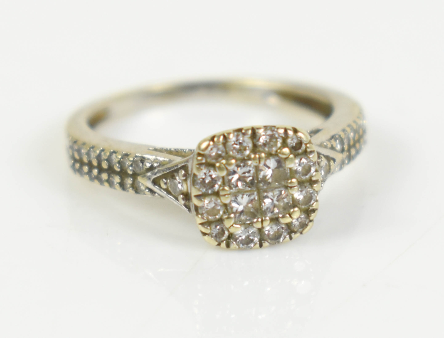 A 14ct white gold and diamond cluster ring of square form, size K, 2.4g.