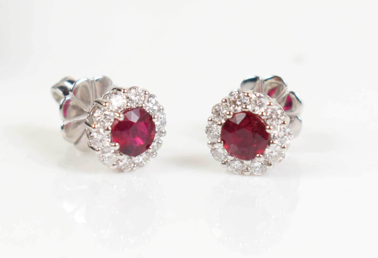 A pair of 18ct white gold, ruby and diamond cluster stud earrings ...