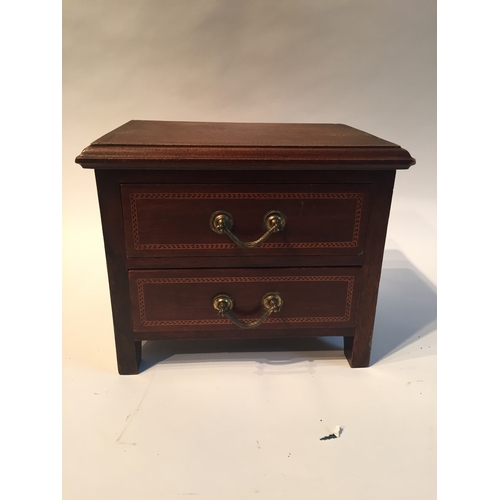 145 - Miniature  two drawer chest measures 20x25x20cms