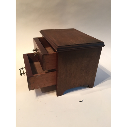 145 - Miniature  two drawer chest measures 20x25x20cms