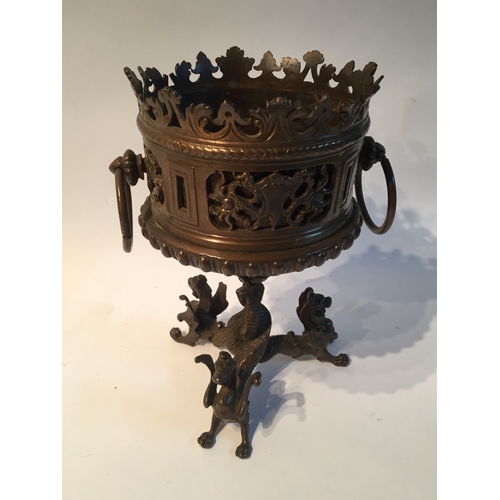 131 - Bronze centrepiece with dragon decorated feet measures 21cms high