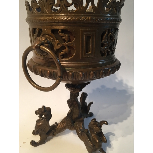 131 - Bronze centrepiece with dragon decorated feet measures 21cms high