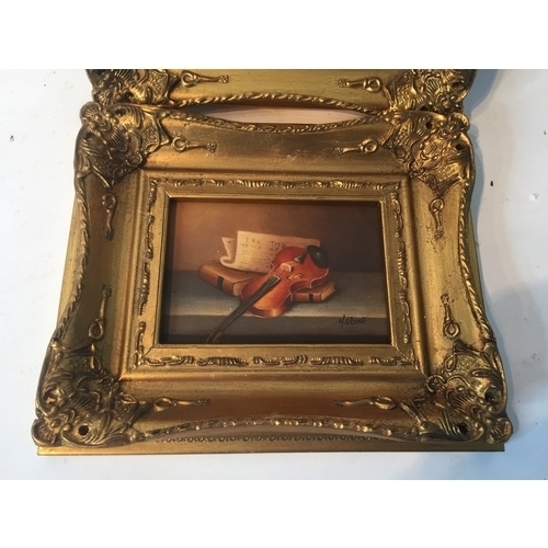 94 - Pair Of gilt Framed Signed Oil On Board Musical Instrument Paintings