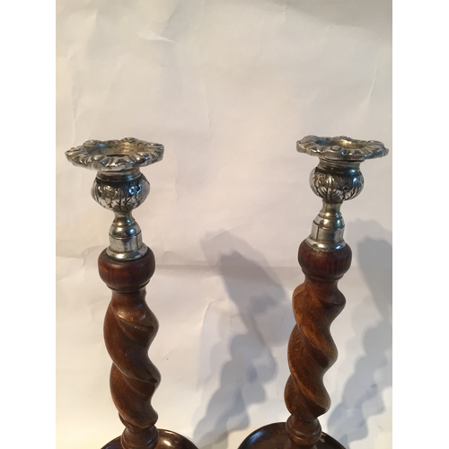 229 - Two Wood Barley Twist Candle sticks with Plated Tops along with a Pewter jug