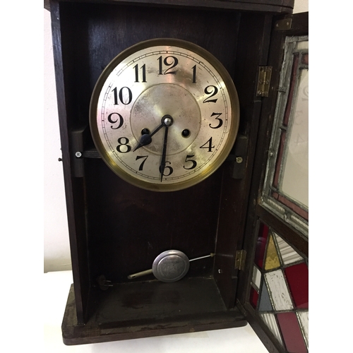 319 - Cased wall clock. Measures 67 x 30 cm