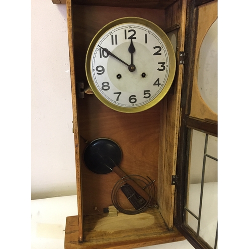 324 - Cased wall clock with pendulum measures 78 x 34 cm