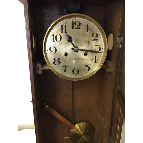 329 - Cased wall clock with pendulum measures 72 x 36 cm