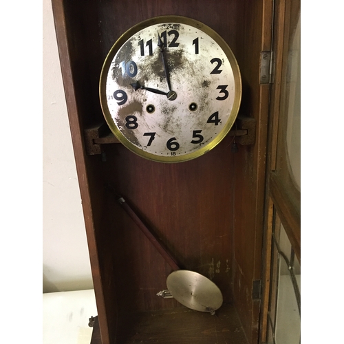 330 - Cased wall clock with pendulum measures 77 x32 cm