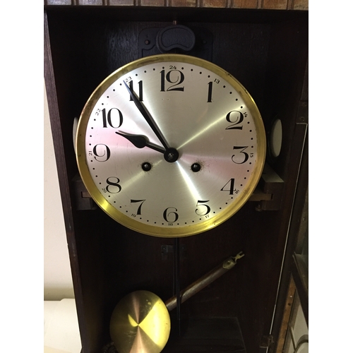 331 - Cased wall clock with pendulum measures 74 x 33 cm