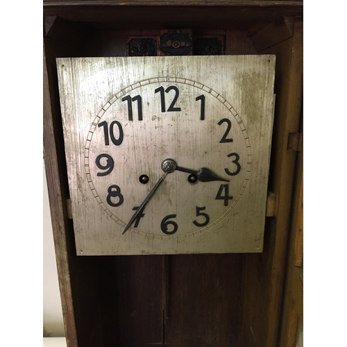 334 - Cased wall clock measures 80 x 40 cm