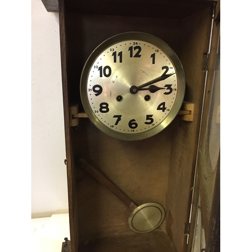 348 - Cased wall clock with pendulum measures 82 x 35 cm