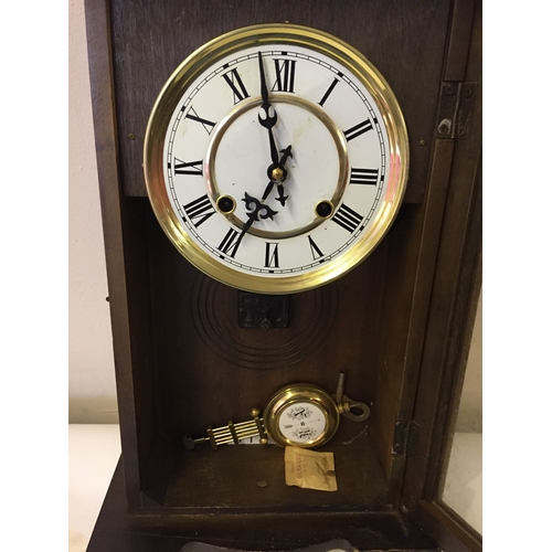 50 - Cased wall clock with pendulum measures 51 x 29 cm