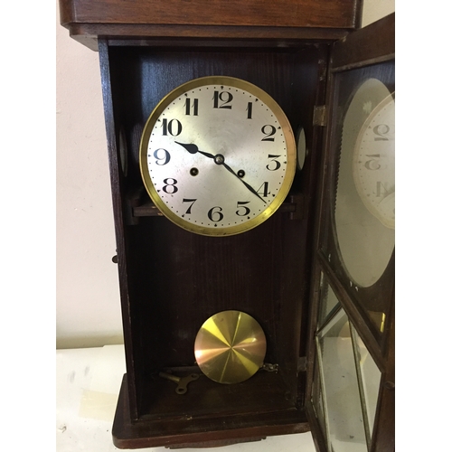 51 - Cased wall clock measures 76 x 31 cm