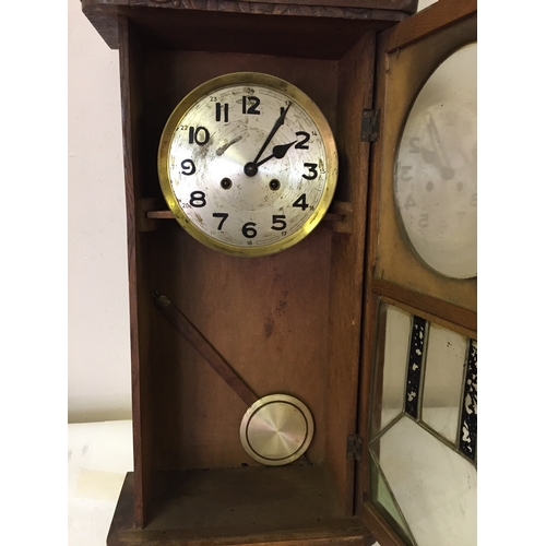 53 - Cased wall clock with pendulum measures 75 x 32 cm