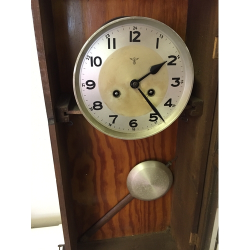 54 - German? Cased wall clock measures 77 x 32 cm