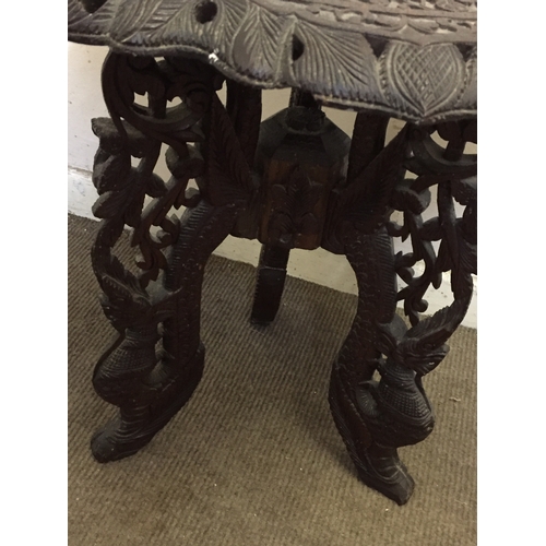 68 - profusely carved Eastern wood table 64cms High