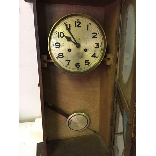 41 - Cased wall clock measures 80 x 35 cm