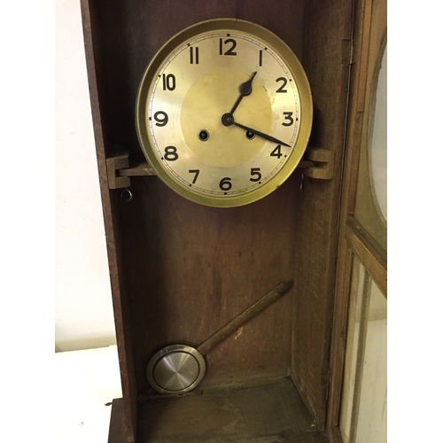 44 - Cased wall clock with pendulum measures 87 x 35 cm