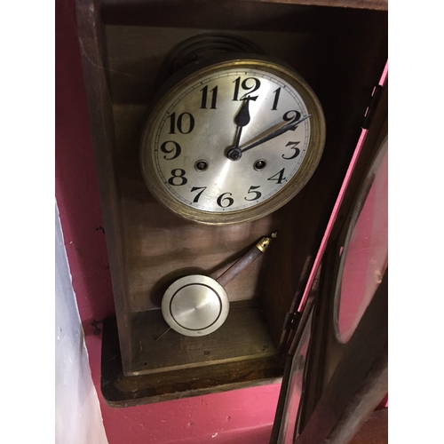 46 - Cased wall clock with pendulum measures 63cm