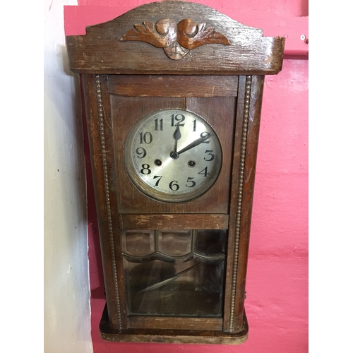 46 - Cased wall clock with pendulum measures 63cm