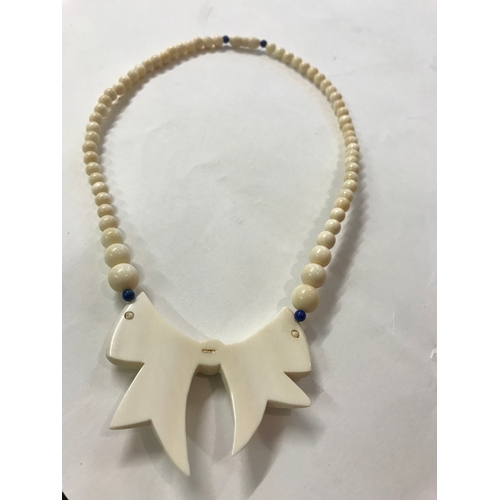 168 - Vintage ivory necklace with stone insert mounted on hallmarked gold mounts