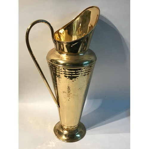 67 - Similar To Previous Lot Large Brass Umbrella Stand In The Form Of A Water Jug Measures 54cm High