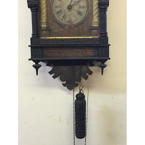 152 - Vintage Weight Driven Wall Clock Wood Cased With Finials.