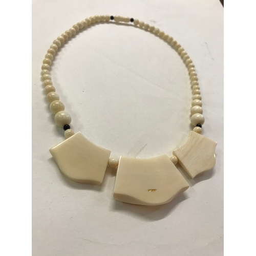 177 - Vintage ivory necklace with stone insert mounted on hallmarked gold mounts