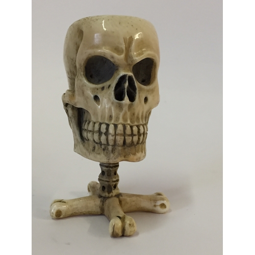 112 - Antique Prisoner of war ivory vesta case in the form of a skull on bone cross standing 6.5cm high