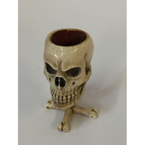 112 - Antique Prisoner of war ivory vesta case in the form of a skull on bone cross standing 6.5cm high