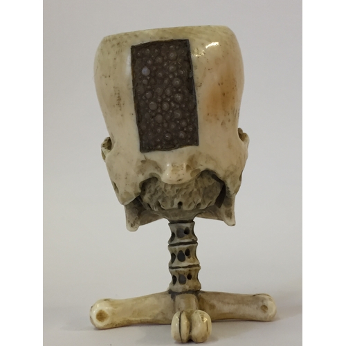 112 - Antique Prisoner of war ivory vesta case in the form of a skull on bone cross standing 6.5cm high