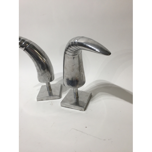 182 - Pair of silver coloured decrotive horns on stands 29cm tall