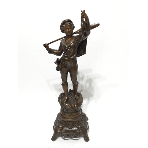 137 - Spelter statue 45cm tall a young boy carrying fish and a net