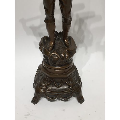 137 - Spelter statue 45cm tall a young boy carrying fish and a net