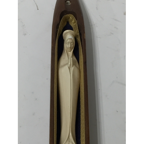 357 - Religious figure in a bobbin Shuttle  41cm long