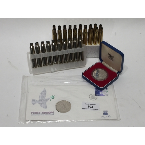 203 - Various spent rifle rounds along with first day cover Guernsey two pound coin and one other