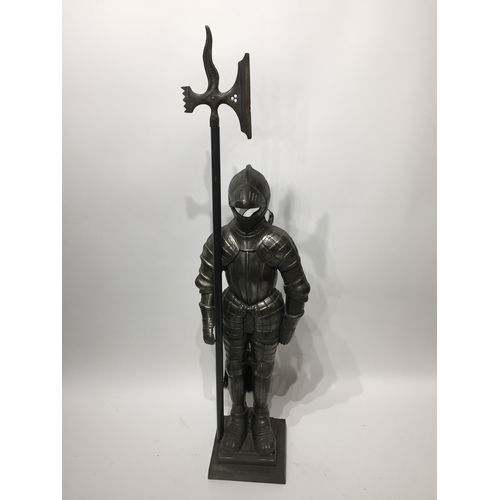 204 - A vintage fire companion set in the form of a knight standing 89cms tall