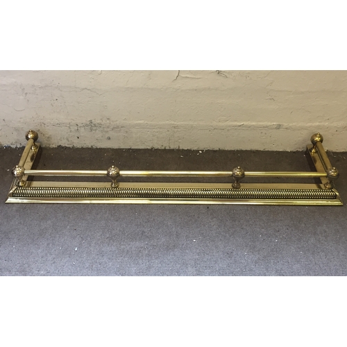 205 - A brass fire surround fender 138 across and recess back 33cms