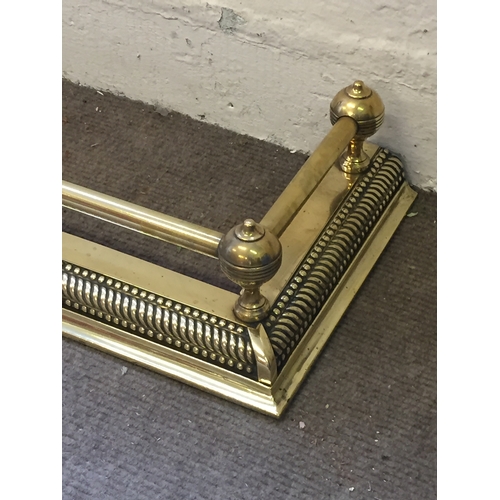 205 - A brass fire surround fender 138 across and recess back 33cms