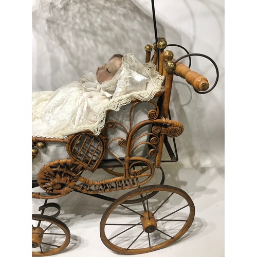 307 - Vintage Cane And Metal Construction Dolls Pram With Lace Sun Canopy  Along With A Ceramic Doll.