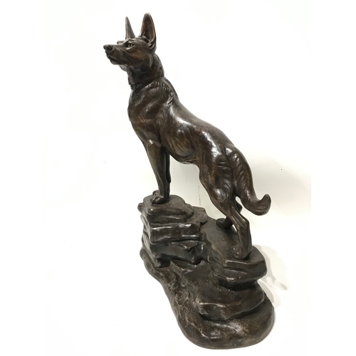 344 - Good Quality Spelter Figure Of A Dog Standing On Rocks Signed L Carvin. Stands 50 cms High