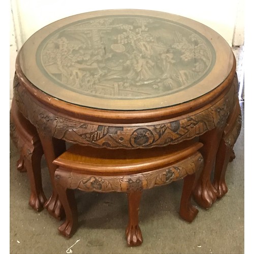 13 - Profusely Carved Oriental Circular Table With Four Pull Out Stools. 80 cms Diameter X 52 Cms High