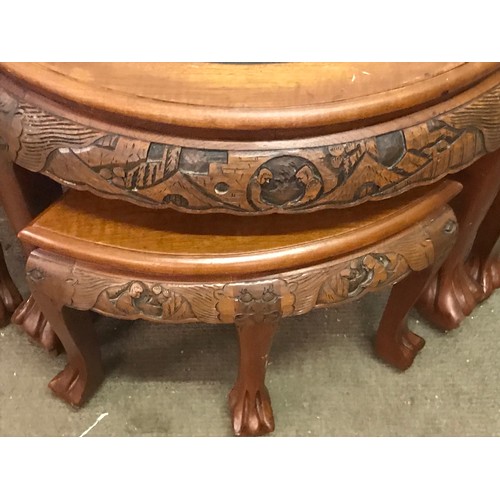 13 - Profusely Carved Oriental Circular Table With Four Pull Out Stools. 80 cms Diameter X 52 Cms High